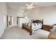 Carpeted bedroom with a wooden bed, white walls, and a walk-in closet at 12104 Baywoods Dr, Tega Cay, SC 29708