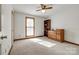 Sun-drenched bedroom with carpeted floor, ceiling fan, and classic dresser near window at 12104 Baywoods Dr, Tega Cay, SC 29708