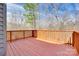 Wood deck overlooking a wooded area, with a wooden railing and a partially covered area at 12104 Baywoods Dr, Tega Cay, SC 29708