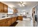 Functional kitchen with oak cabinets, white appliances, and adjacent breakfast nook area at 12104 Baywoods Dr, Tega Cay, SC 29708