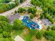 Aerial shot of colorful playground with a modern design surrounded by trees and ample parking at 12104 Baywoods Dr, Tega Cay, SC 29708