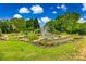 Beautiful garden pond with a fountain, surrounded by flowers, landscaping, and a manicured lawn at 12104 Baywoods Dr, Tega Cay, SC 29708