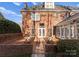 Brick backyard patio features bench seating and ample light on a brick home with white trim at 1604 Windy Ridge Rd, Charlotte, NC 28270