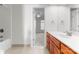 Bright bathroom featuring a single vanity, tile floors and view into adjacent bedroom at 1604 Windy Ridge Rd, Charlotte, NC 28270