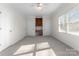 Bright bedroom featuring neutral tones, a ceiling fan, and a built-in desk with shelving at 1604 Windy Ridge Rd, Charlotte, NC 28270