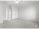 Neutral bedroom featuring plush carpet, crown moulding, and a walk-in closet at 1604 Windy Ridge Rd, Charlotte, NC 28270