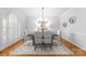 Elegant dining room with modern chandelier, neutral color palette, and hardwood floors at 1604 Windy Ridge Rd, Charlotte, NC 28270