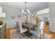 Dining area featuring stylish decor, chandelier lighting, and hardwood floors at 1604 Windy Ridge Rd, Charlotte, NC 28270