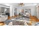 Sunlit living room features modern decor and neutral tones, with a stylish rug and a ceiling fan at 1604 Windy Ridge Rd, Charlotte, NC 28270