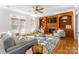 Inviting living room featuring hardwood floors, a fireplace, and built-in bookshelves at 1604 Windy Ridge Rd, Charlotte, NC 28270