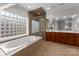 Bright main bathroom with a soaking tub, glass block window, and a separate glass shower at 1604 Windy Ridge Rd, Charlotte, NC 28270