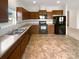 Kitchen with dark cabinets and appliances at 1633 Barroso Ln, Charlotte, NC 28213