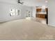 Open living room and kitchen area with neutral carpeting at 1633 Barroso Ln, Charlotte, NC 28213