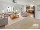 Virtually staged living room with gray sofas and a wooden coffee table at 1633 Barroso Ln, Charlotte, NC 28213