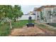 The backyard features a fire pit, grill, patio area, and lush lawn, perfect for outdoor gatherings at 164 N Cromwell Dr, Mooresville, NC 28115