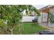 The backyard features a peach tree, patio area, a grill and a well maintained lawn at 164 N Cromwell Dr, Mooresville, NC 28115