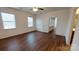 Spacious bedroom featuring hardwood floors, two windows, and a ceiling fan at 164 N Cromwell Dr, Mooresville, NC 28115