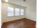 Bright bedroom with three windows and hardwood floors at 164 N Cromwell Dr, Mooresville, NC 28115