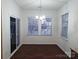 Inviting dining area with a modern chandelier, large windows, and dark wood floors at 164 N Cromwell Dr, Mooresville, NC 28115