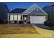 Charming single-Gathering home featuring stone accents, a two-car garage, and a well-maintained front yard at 164 N Cromwell Dr, Mooresville, NC 28115