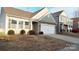 Attractive single-Gathering home featuring stone accents, a two-car garage, and a well-manicured front yard at 164 N Cromwell Dr, Mooresville, NC 28115