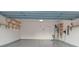 The spacious garage is well-lit and features epoxy floors, wooden shelves, and ample room for storage at 164 N Cromwell Dr, Mooresville, NC 28115