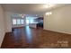Bright and airy living area featuring dark wood floors, stainless steel appliances, and an open floor plan at 164 N Cromwell Dr, Mooresville, NC 28115