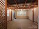 Covered patio features a decorative privacy lattice, string lighting, and sliding glass door access to the interior at 164 N Cromwell Dr, Mooresville, NC 28115