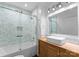 Modern bathroom featuring subway tile shower, glass door, and wood vanity with rectangular sink at 1740 Wilmore Dr, Charlotte, NC 28203