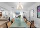 Bright dining room featuring a glass table, modern chandelier, and seamless transition to adjacent living areas at 1740 Wilmore Dr, Charlotte, NC 28203