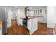 Spacious kitchen with an island cooktop, stainless steel range hood, and contrasting butcher block countertops at 1740 Wilmore Dr, Charlotte, NC 28203