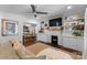 Bright living room with white brick fireplace and a view to the adjacent dining room at 1740 Wilmore Dr, Charlotte, NC 28203