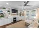 Bright living room with white brick fireplace, built-in shelving, hardwood floors and a cozy couch at 1740 Wilmore Dr, Charlotte, NC 28203