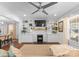 Bright living room with white brick fireplace, built-in shelving, and a comfortable seating area at 1740 Wilmore Dr, Charlotte, NC 28203