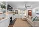 Bright living room with white brick fireplace, built-in shelving, hardwood floors, and a cozy couch at 1740 Wilmore Dr, Charlotte, NC 28203