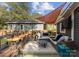 Relaxing outdoor deck with seating area, bar stools, overhead lighting, and a shade sail at 1740 Wilmore Dr, Charlotte, NC 28203