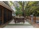 Charming outdoor deck with dining table, shade trees, overhead lighting, and a grill at 1740 Wilmore Dr, Charlotte, NC 28203