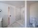 Bathroom with a walk-in shower, toilet and marble floors at 204 Regency Rd, Mooresville, NC 28117