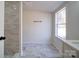 Clean bathroom with marble floor and shower with subway tile at 204 Regency Rd, Mooresville, NC 28117