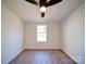 Bright bedroom with wood floors, ceiling fan, and window at 204 Regency Rd, Mooresville, NC 28117