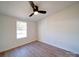 Bright bedroom with wood floors, ceiling fan, and window at 204 Regency Rd, Mooresville, NC 28117