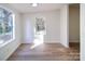 Simple dining area with light wood floors and large windows at 204 Regency Rd, Mooresville, NC 28117