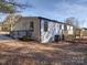 Side view of the home, showcasing a deck and yard at 204 Regency Rd, Mooresville, NC 28117