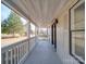 Inviting front porch with white railings and view of yard at 204 Regency Rd, Mooresville, NC 28117