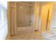 Updated bathroom with bathtub, window, and linen closet at 2541 Pinewood Rd, Gastonia, NC 28054