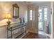 Bright entryway with glass-top console table and patterned rug at 2541 Pinewood Rd, Gastonia, NC 28054