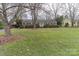 Ranch style home with tree-lined lawn at 2541 Pinewood Rd, Gastonia, NC 28054