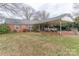 Brick ranch house with carport, screened porch, and spacious backyard at 2541 Pinewood Rd, Gastonia, NC 28054