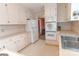 Galley kitchen with white cabinets and stainless steel appliances at 2541 Pinewood Rd, Gastonia, NC 28054