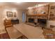 Living room with brick fireplace, built-in shelving, and hardwood floors at 2541 Pinewood Rd, Gastonia, NC 28054